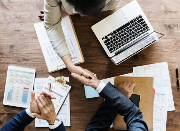 Business people shaking hands together