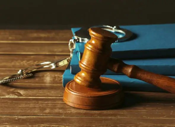 Gavel With Books On Old Wooden Desk