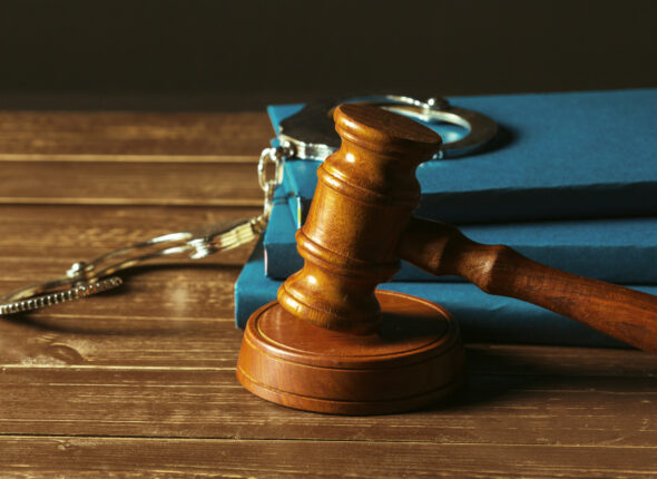 Gavel With Books On Old Wooden Desk