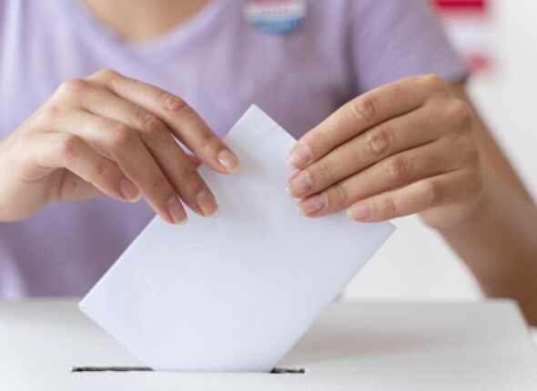 person-placing-its-vote-box