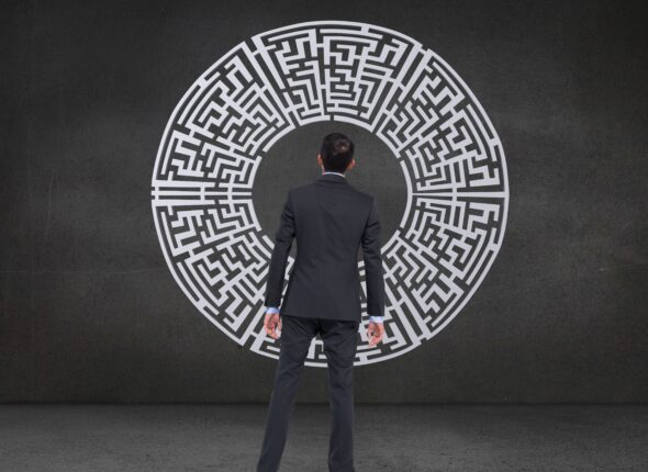 rear-view-businessman-looking-maze